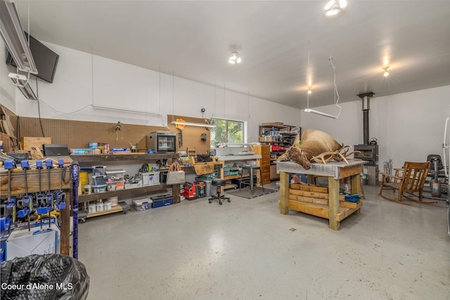 8718 W Sausser Dr, Coeur Dalene, ID 83814 - garage with a workshop area and a wood stove