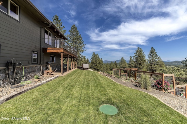 8718 W Sausser Dr, Coeur Dalene, ID 83814 - view of green lawn featuring a mountain view and a vegetable garden