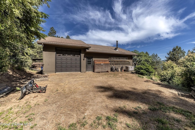 8718 W Sausser Dr, Coeur Dalene, ID 83814 - view of front of house with a garage and dirt driveway