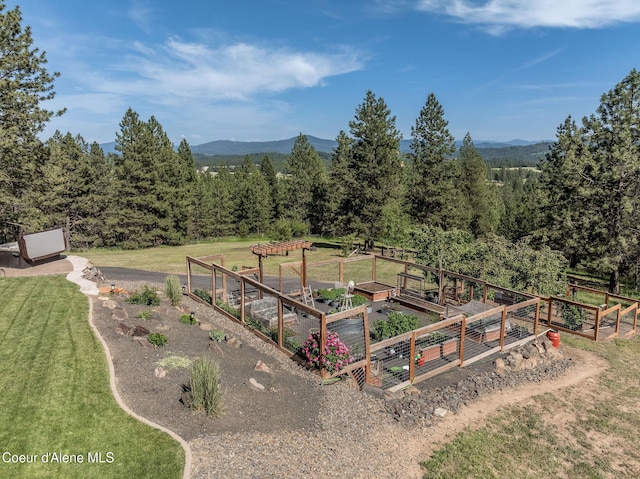 8718 W Sausser Dr, Coeur Dalene, ID 83814 - view of green lawn with a vegetable garden and a mountain view