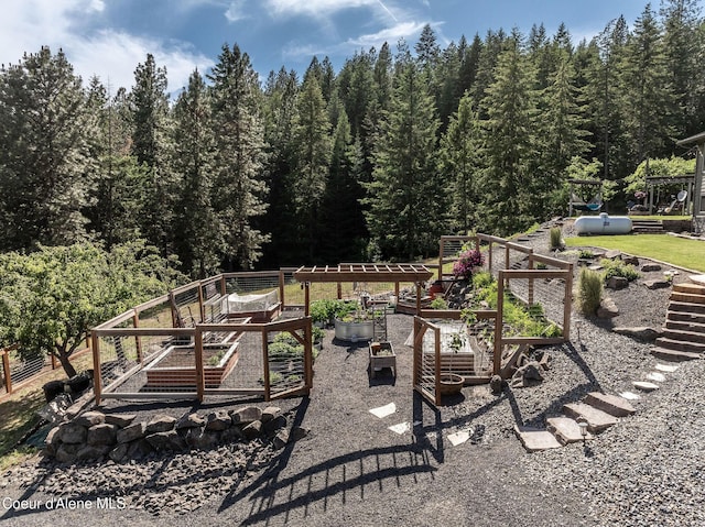 8718 W Sausser Dr, Coeur Dalene, ID 83814 - view of yard with a vegetable garden and a view of trees