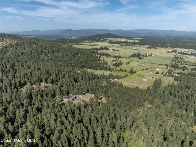 8718 W Sausser Dr, Coeur Dalene, ID 83814 - aerial view of property's location with mountains and a heavily wooded area