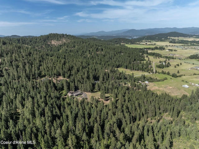 8718 W Sausser Dr, Coeur Dalene, ID 83814 - aerial view of property's location featuring a heavily wooded area and mountains