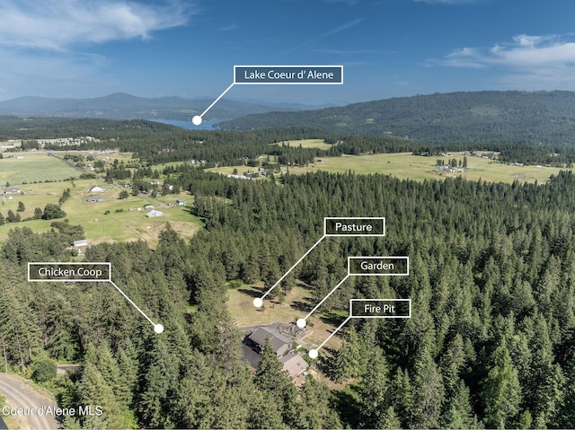 8718 W Sausser Dr, Coeur Dalene, ID 83814 - aerial view of property's location featuring a mountain backdrop and property parcel outlined
