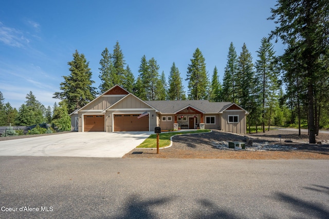 80 Parkland Dr, Blanchard, ID 83804 - view of front of home featuring board and batten siding, an attached garage, and driveway