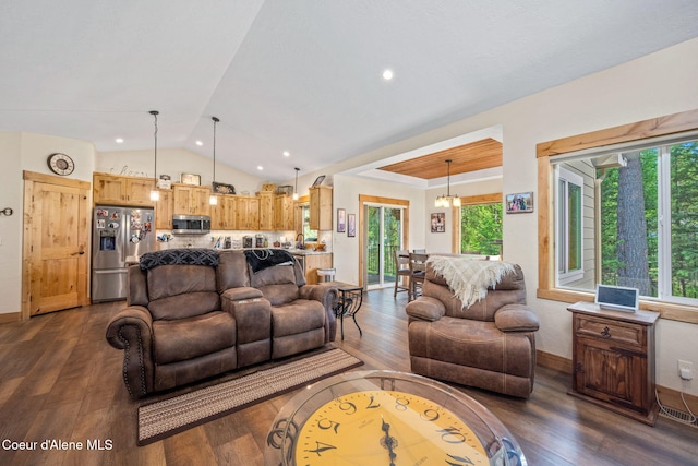 80 Parkland Dr, Blanchard, ID 83804 - living room with lofted ceiling, dark wood-style floors, and a chandelier