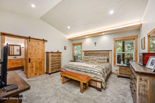 80 Parkland Dr, Blanchard, ID 83804 - bedroom featuring multiple windows, light carpet, recessed lighting, lofted ceiling, and a barn door