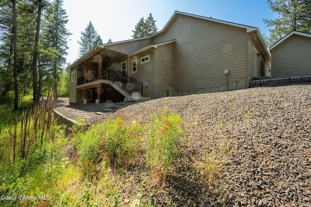 80 Parkland Dr, Blanchard, ID 83804 - back of property featuring ceiling fan and stairs
