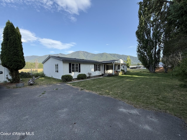 3135 Paradise Valley Rd, Bonners Ferry, ID 83805 - ranch-style home with a mountain view and a front lawn