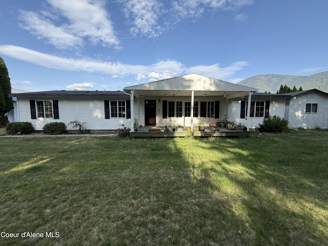 3135 Paradise Valley Rd, Bonners Ferry, ID 83805 - view of front facade featuring a mountain view and a front lawn