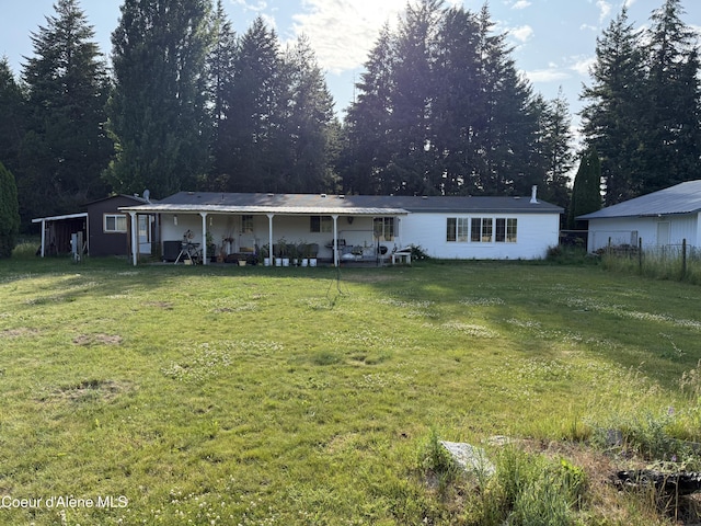 3135 Paradise Valley Rd, Bonners Ferry, ID 83805 - back of property with a yard and a patio area