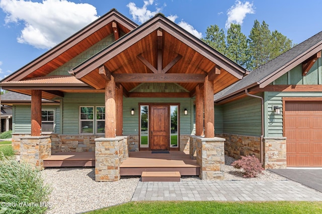 357 Odonnell Dr, Dover, ID 83825 - doorway to property featuring stone siding, a porch, and an attached garage