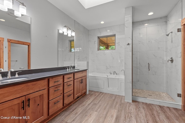357 Odonnell Dr, Dover, ID 83825 - full bathroom featuring a bath, a stall shower, wood finished floors, double vanity, and a skylight