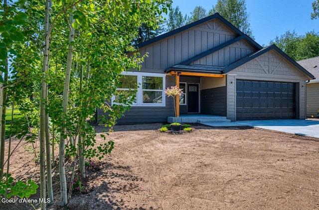 233 Jasper Loop, Ponderay, ID 83852 - view of front of home featuring an attached garage, concrete driveway, and board and batten siding