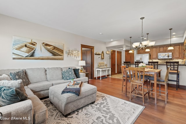 2050 N Main St # 208, Coeur Dalene, ID 83814 - living area featuring wood finished floors and a chandelier