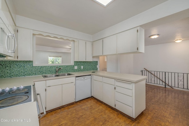 6300 N Sunrise Ter, Coeur Dalene, ID 83815 - kitchen with white appliances, decorative backsplash, light countertops, wood finished floors, and a peninsula