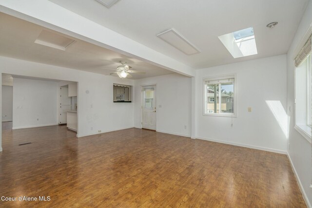 6300 N Sunrise Ter, Coeur Dalene, ID 83815 - unfurnished living room with wood finished floors and a skylight