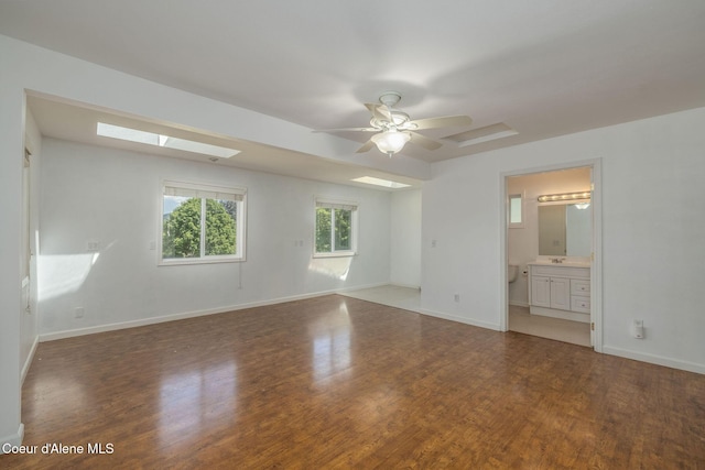 6300 N Sunrise Ter, Coeur Dalene, ID 83815 - spare room featuring wood finished floors, ceiling fan, and a skylight