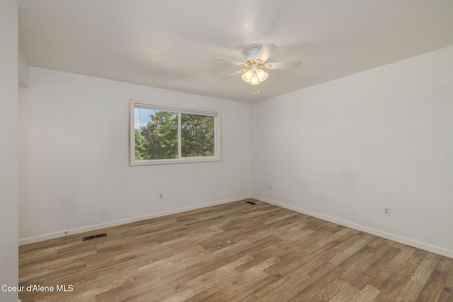 6300 N Sunrise Ter, Coeur Dalene, ID 83815 - spare room with wood finished floors and ceiling fan