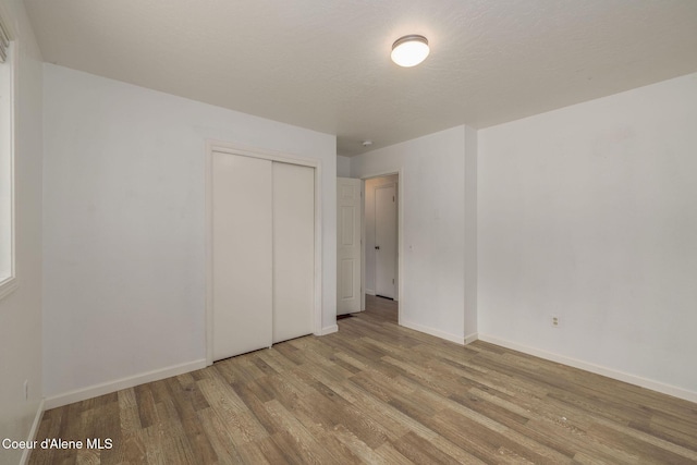 6300 N Sunrise Ter, Coeur Dalene, ID 83815 - unfurnished bedroom with wood finished floors and a closet