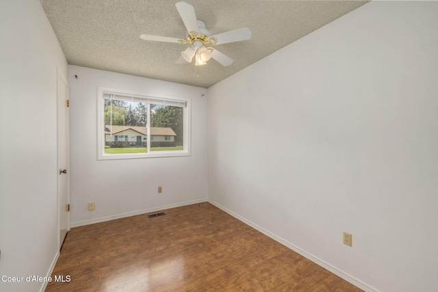 6300 N Sunrise Ter, Coeur Dalene, ID 83815 - empty room featuring a textured ceiling, wood finished floors, and a ceiling fan
