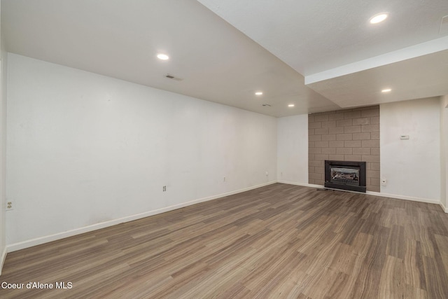 6300 N Sunrise Ter, Coeur Dalene, ID 83815 - unfurnished living room featuring wood finished floors, recessed lighting, and a fireplace