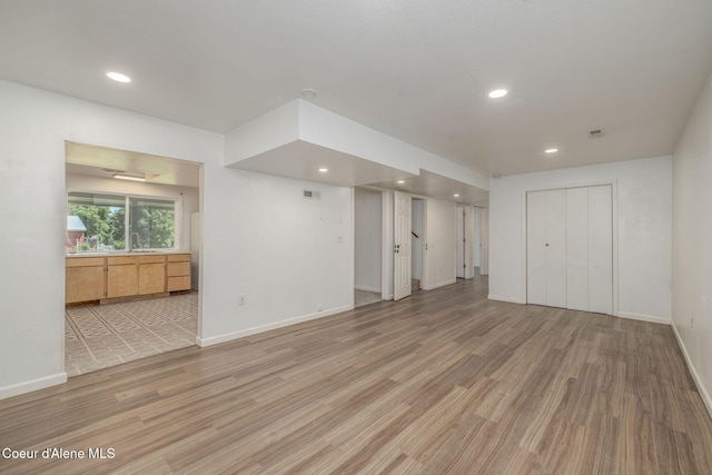 6300 N Sunrise Ter, Coeur Dalene, ID 83815 - unfurnished living room featuring light wood-type flooring and recessed lighting