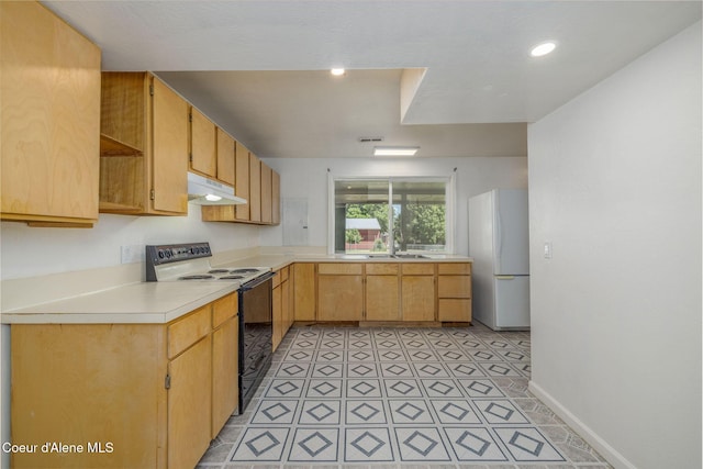 6300 N Sunrise Ter, Coeur Dalene, ID 83815 - kitchen with range with electric cooktop, freestanding refrigerator, under cabinet range hood, and light countertops