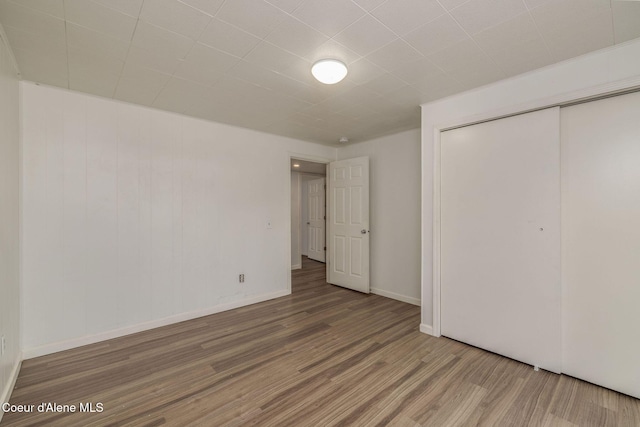 6300 N Sunrise Ter, Coeur Dalene, ID 83815 - unfurnished bedroom featuring wood finished floors and a closet