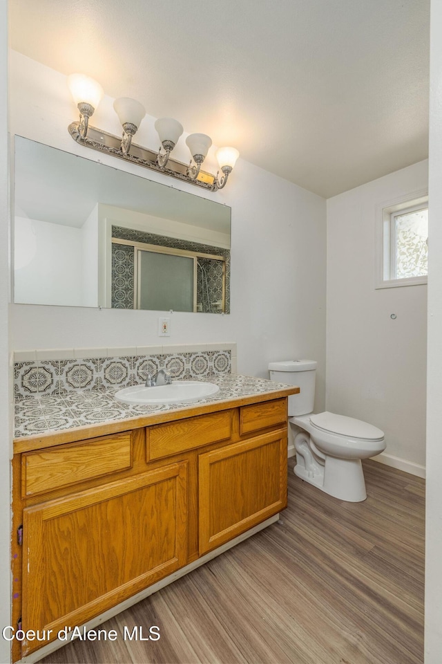 6300 N Sunrise Ter, Coeur Dalene, ID 83815 - full bathroom featuring vanity, wood finished floors, and a shower