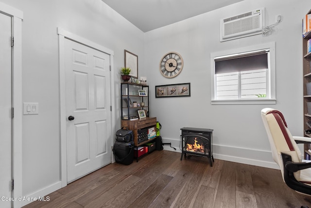 709 E 14th Ave, Post Falls, ID 83854 - office area with wood finished floors, a wall mounted air conditioner, and a wood stove