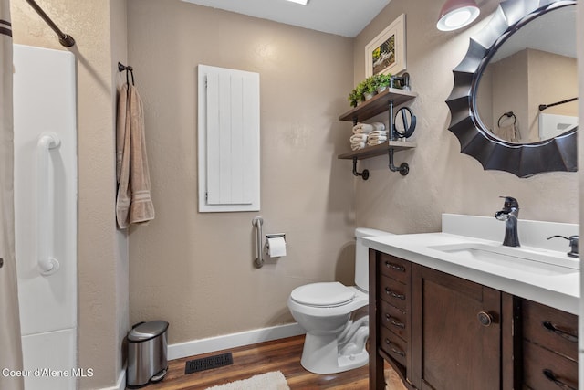 709 E 14th Ave, Post Falls, ID 83854 - bathroom featuring wood finished floors, vanity, and a shower