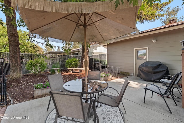 709 E 14th Ave, Post Falls, ID 83854 - fenced backyard featuring a patio area, outdoor dining space, and grilling area