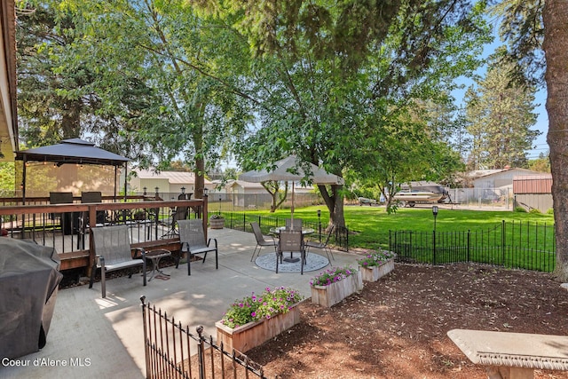709 E 14th Ave, Post Falls, ID 83854 - fenced backyard with a patio, outdoor dining area, area for grilling, and a residential view