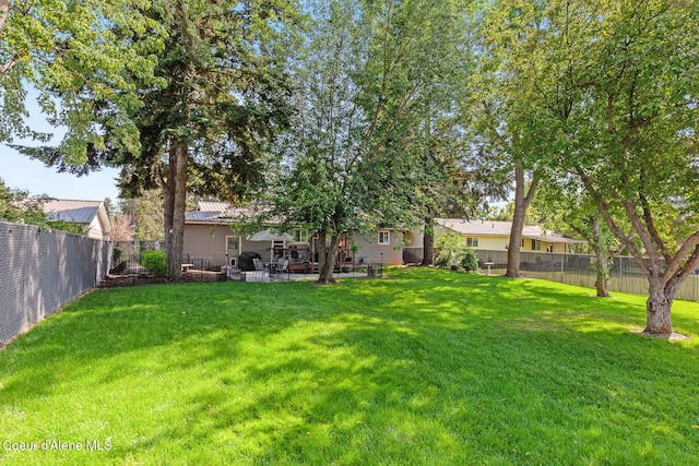 709 E 14th Ave, Post Falls, ID 83854 - fenced backyard featuring a patio