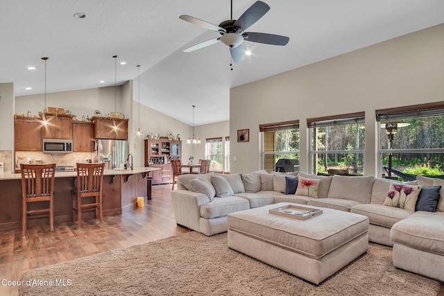 20770 N Penobscot Rd, Rathdrum, ID 83858 - living room with high vaulted ceiling, light wood finished floors, a ceiling fan, a chandelier, and recessed lighting