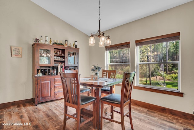20770 N Penobscot Rd, Rathdrum, ID 83858 - dining room with light wood finished floors, lofted ceiling, and a chandelier