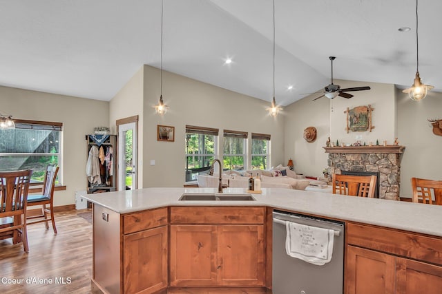 20770 N Penobscot Rd, Rathdrum, ID 83858 - kitchen with dishwasher, vaulted ceiling, light countertops, light wood-style flooring, and a ceiling fan