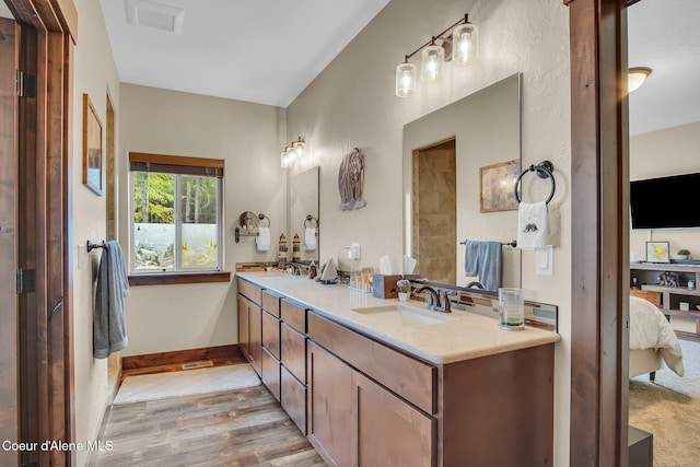 20770 N Penobscot Rd, Rathdrum, ID 83858 - ensuite bathroom featuring double vanity and wood finished floors