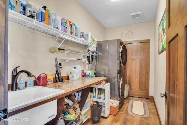 20770 N Penobscot Rd, Rathdrum, ID 83858 - laundry room with stacked washer and clothes dryer and wood finished floors