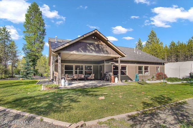 20770 N Penobscot Rd, Rathdrum, ID 83858 - rear view of property with a patio area, a lawn, an outdoor living space, and a greenhouse