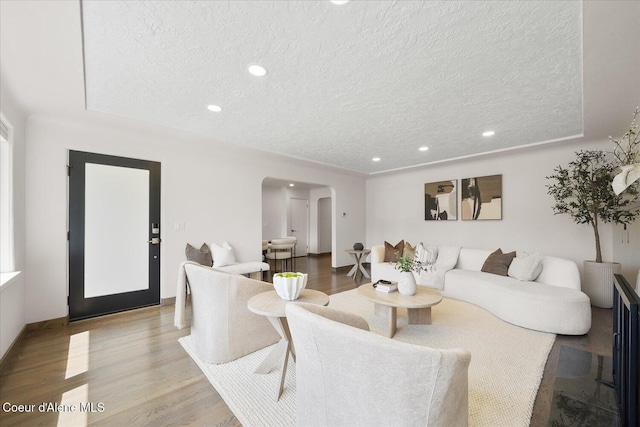 1217 E Montana Ave, Coeur Dalene, ID 83814 - living area featuring arched walkways, a textured ceiling, wood finished floors, and recessed lighting