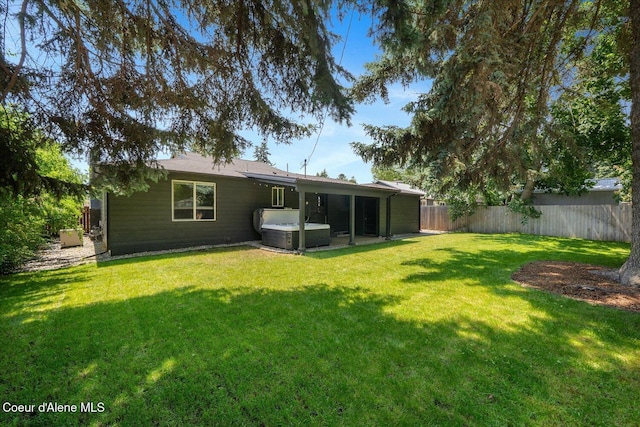 1217 E Montana Ave, Coeur Dalene, ID 83814 - rear view of house featuring a hot tub and a fenced backyard