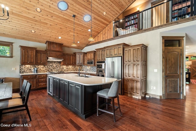 11 Canoe Cv, Dover, ID 83825 - kitchen featuring light countertops, high quality fridge, dark wood-style floors, wood ceiling, and a center island with sink