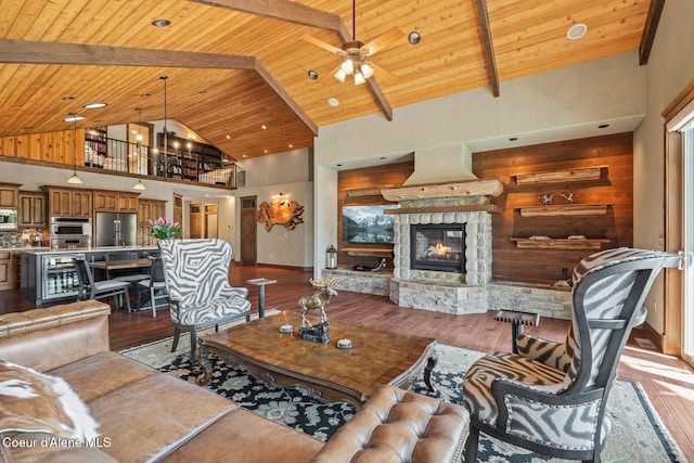 11 Canoe Cv, Dover, ID 83825 - living room featuring a wooden ceiling with exposed beams, a ceiling fan, hardwood / wood-style floors, a fireplace, and high vaulted ceiling