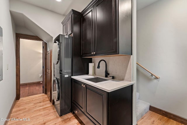 11 Canoe Cv, Dover, ID 83825 - laundry room featuring estacked washer and dryer, cabinet space, and light wood-style floors