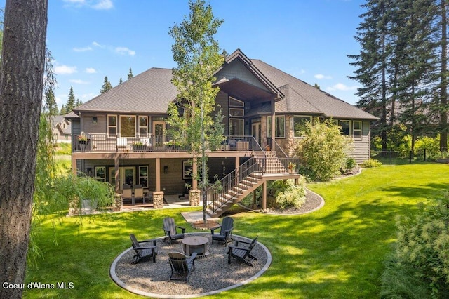 3742 W Cielo View Ct, Coeur Dalene, ID 83814 - rear view of property featuring a fire pit, a deck, and a lawn