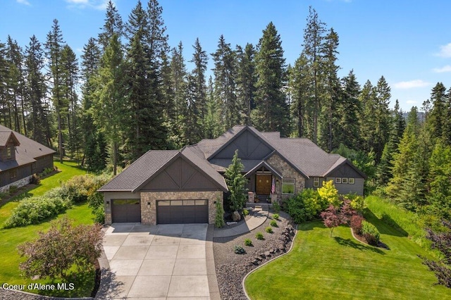 3742 W Cielo View Ct, Coeur Dalene, ID 83814 - view of front of house with an attached garage, driveway, a front yard, and a wooded view