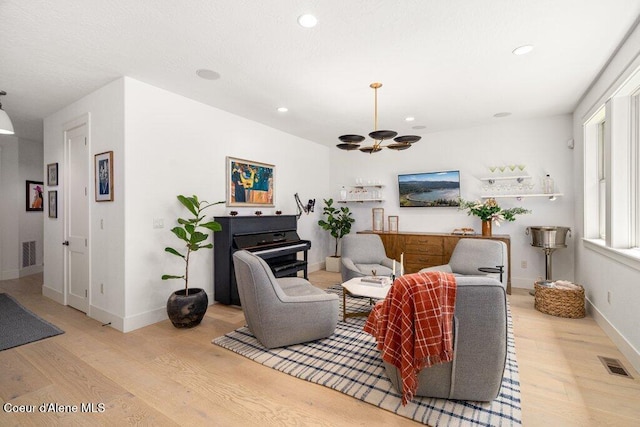 3742 W Cielo View Ct, Coeur Dalene, ID 83814 - living room featuring wood finished floors, recessed lighting, and a chandelier