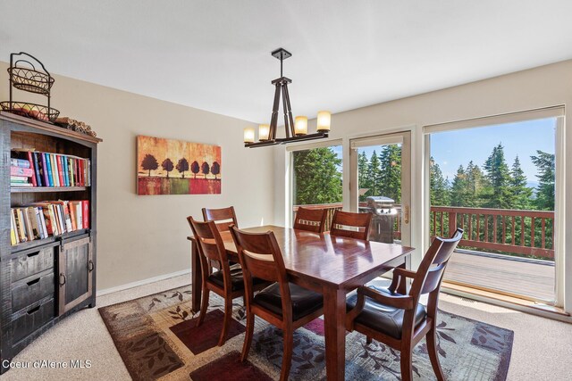 7722 W Clemetson Rd, Coeur Dalene, ID 83814 - carpeted dining area featuring a chandelier and baseboards